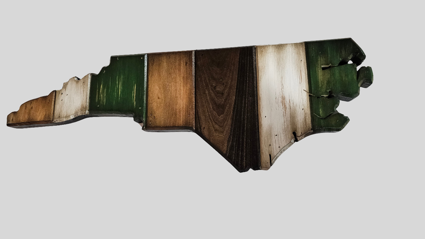 close-up picture of North Carolina Wooden wall art with green accent color in a state shaped map design on a white background.