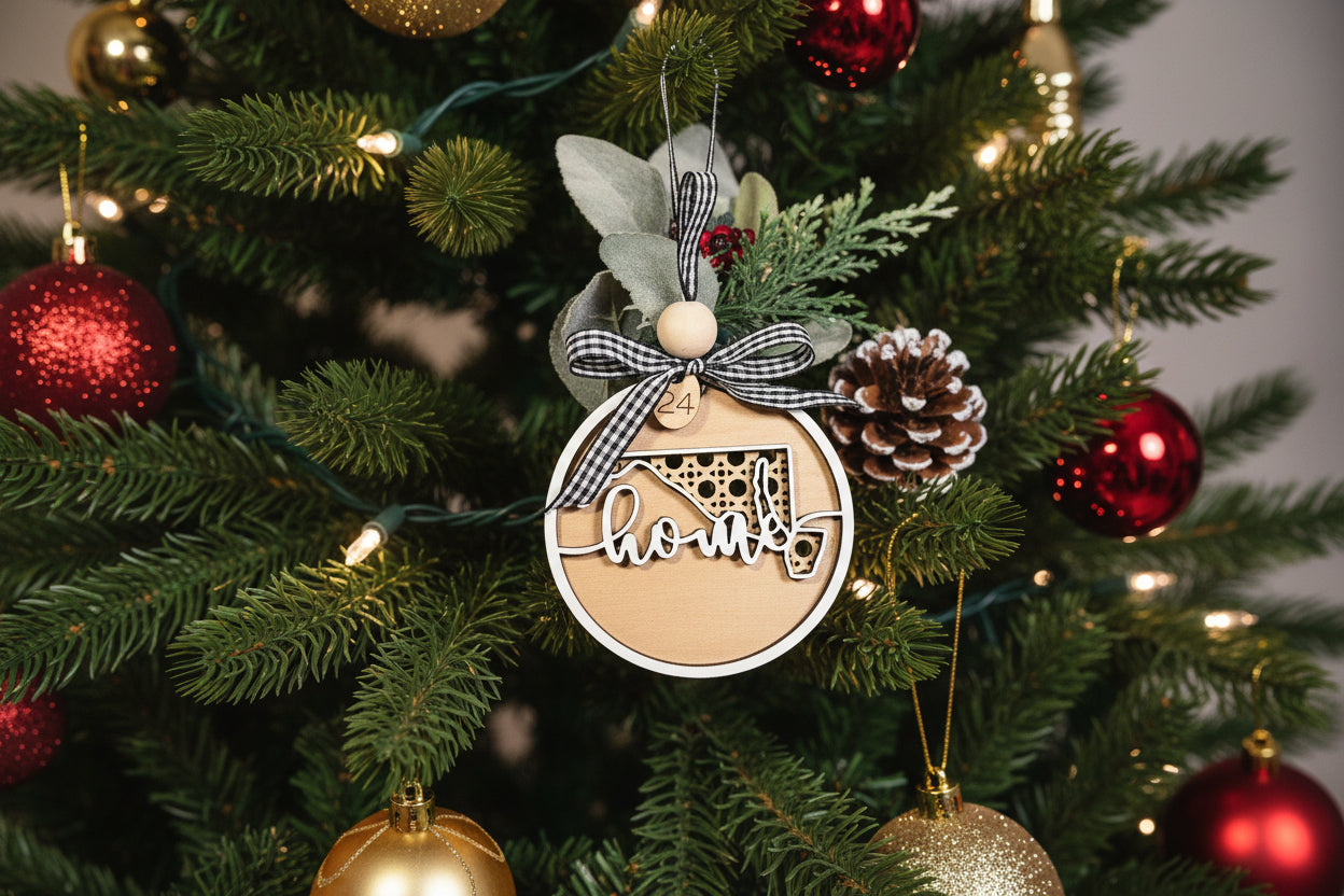Decorative Maryland Christmas ornament with 'home' text, poinsettia, and greenery on a white background