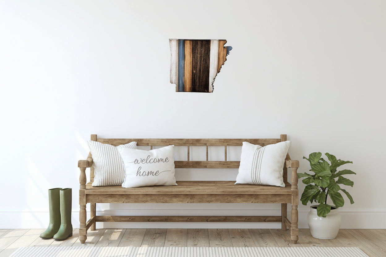 Wooden bench with decorative Arkansas wall art, pillows and a plant in a room