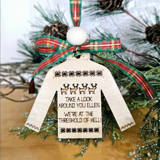 Funny Christmas ornament with an ugly sweater design. Engraved quote from National Lampoons Christmas Vacation hanging on a branch.