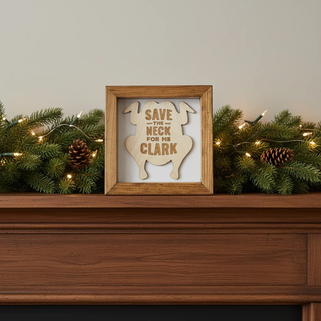 Wooden frame with a cutout of a turkey and text 'Save the Neck for me Clark' on a white background, inspired by the classic movie National Lampoon's Christmas Vacation.