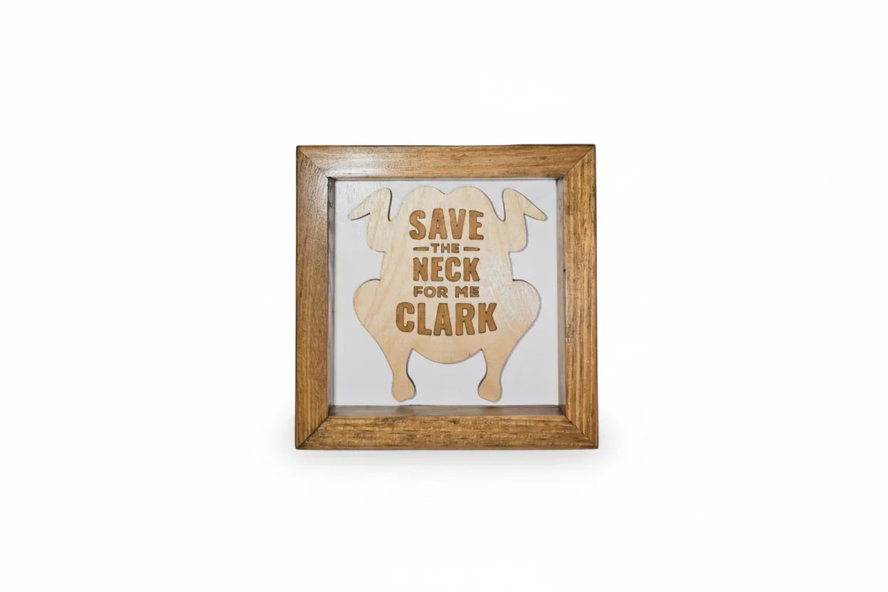 Wooden frame with a cutout of a turkey and text 'Save the Neck for me Clark' on a white background