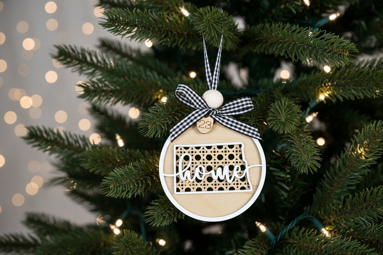 Christmas ornament with 'home' text on a decorated tree