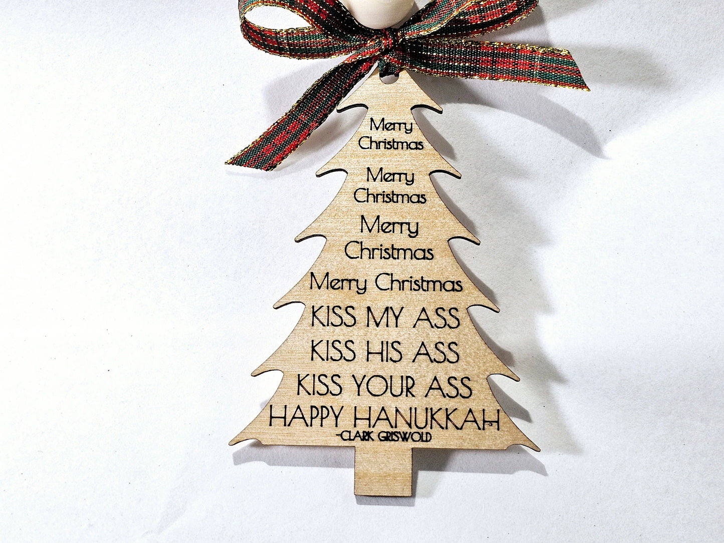 Wooden Christmas tree ornament with Clark Griswold rant from the movie, National Lampoon's Christmas Vacation, and a bow on a white background