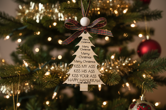 Decorative Christmas ornament with humorous text, from the iconic National Lampoon's Christmas Vacation, on a Christmas tree.