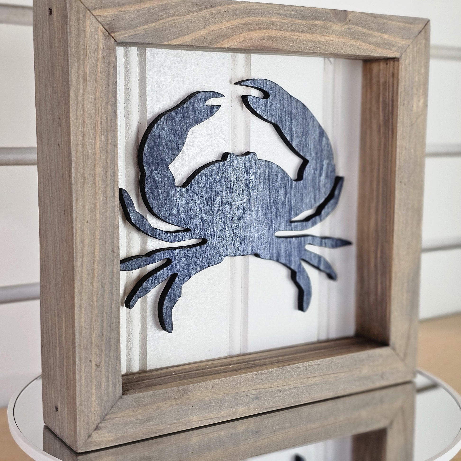 Handmade Wooden frame with a blue crab cutout on a white background
