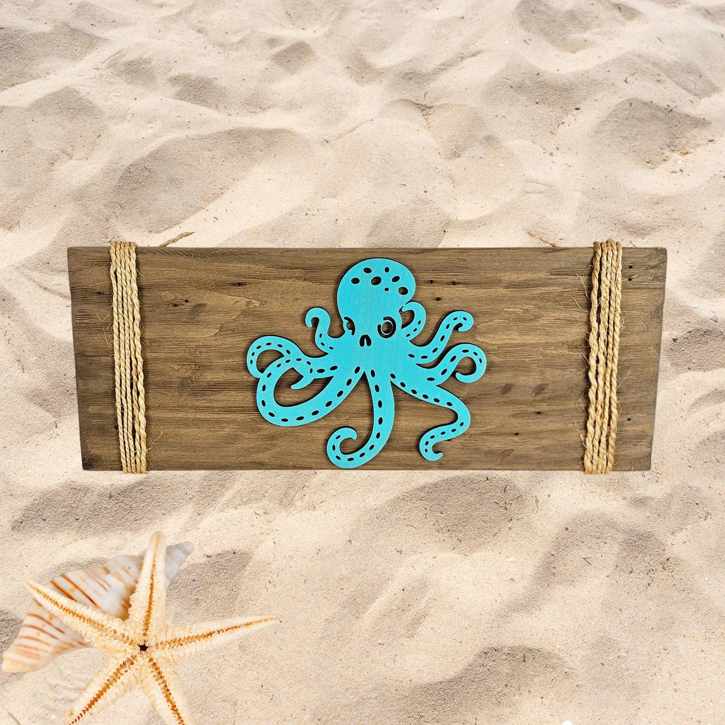 Rustic octopus wood wall art handcrafted ocean decor on sandy beach background