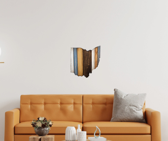 A handmade wooden cutout in the shape of the state of Ohio, with a rustic, distressed finish and a wire hanger on the back.