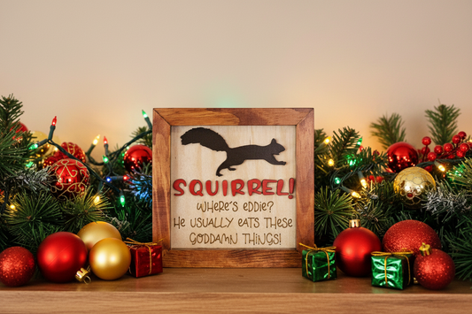 Framed sign with squirrel design and quote inspired by the movie classic, National Lampoon's Christmas Vacation. and Christmas decorations on a table.