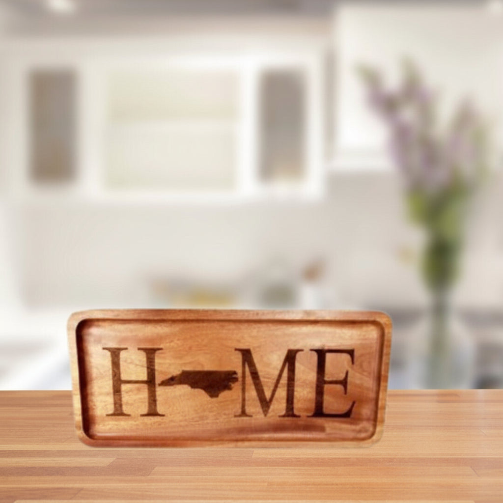 Wooden sign with 'HOME' and a state outline on a blurred kitchen background