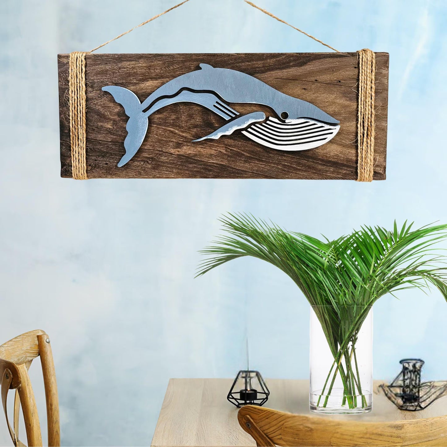 Humpback whale wood wall art handcrafted coastal decor above console table with plant and candles