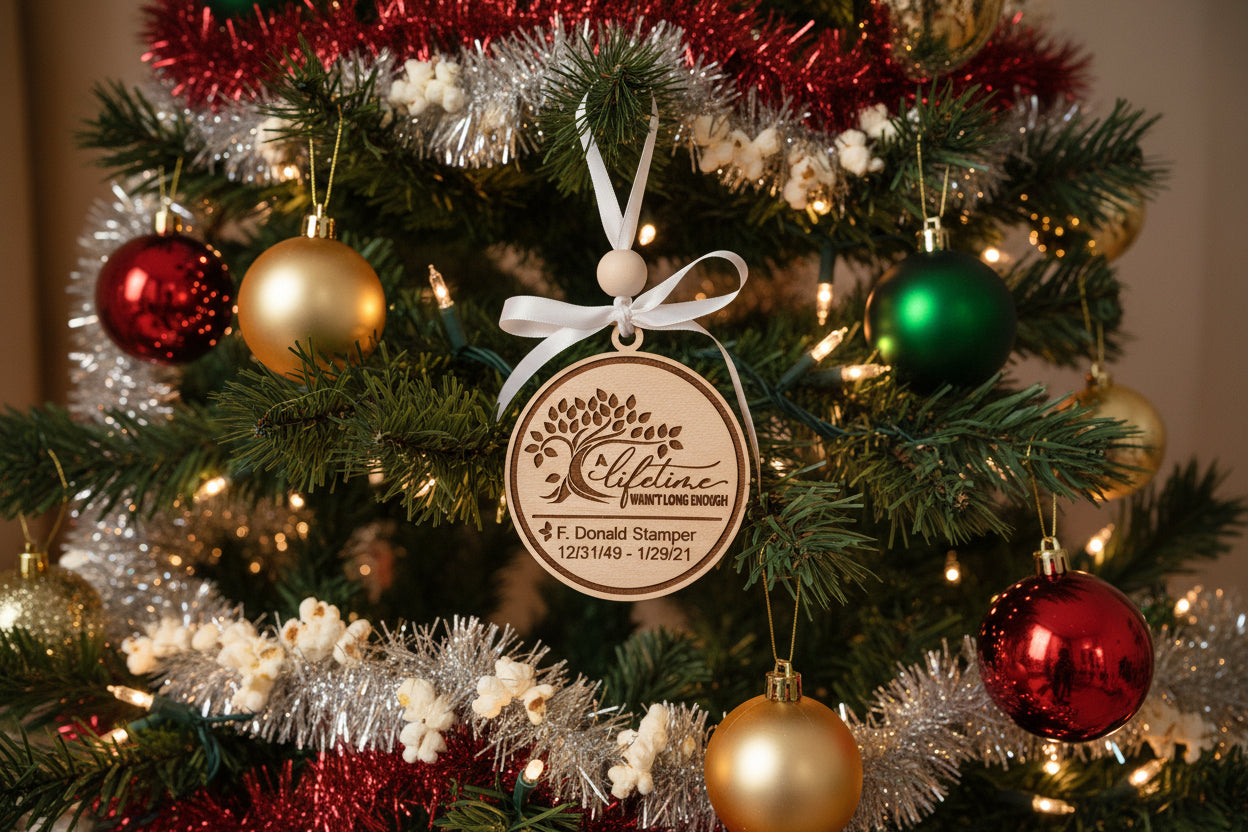 Wooden, custom, memorial ornament with engraved text on the ornament and hanging from a holiday tree.