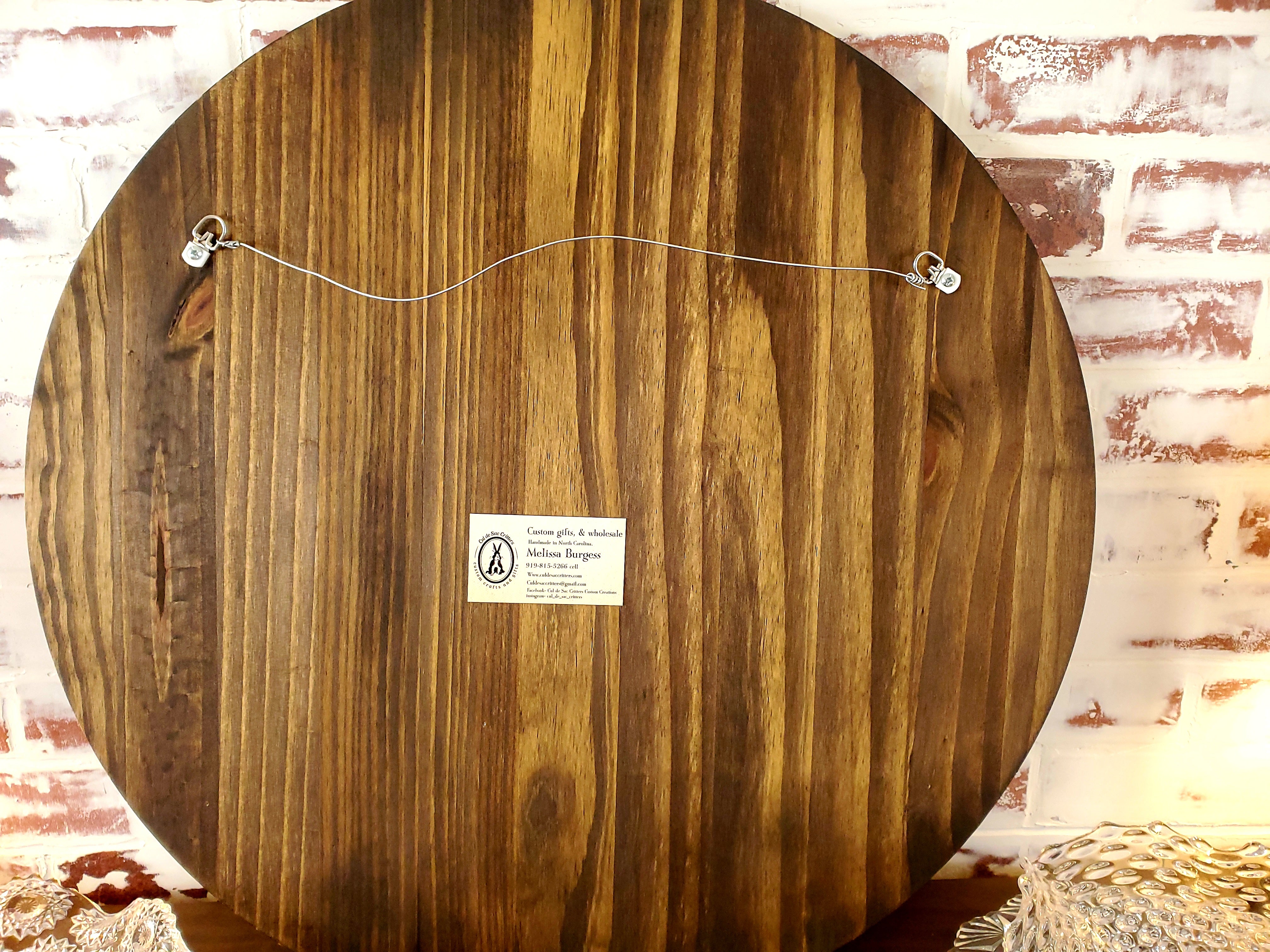 Back of round board showcasing the hanging hardware.